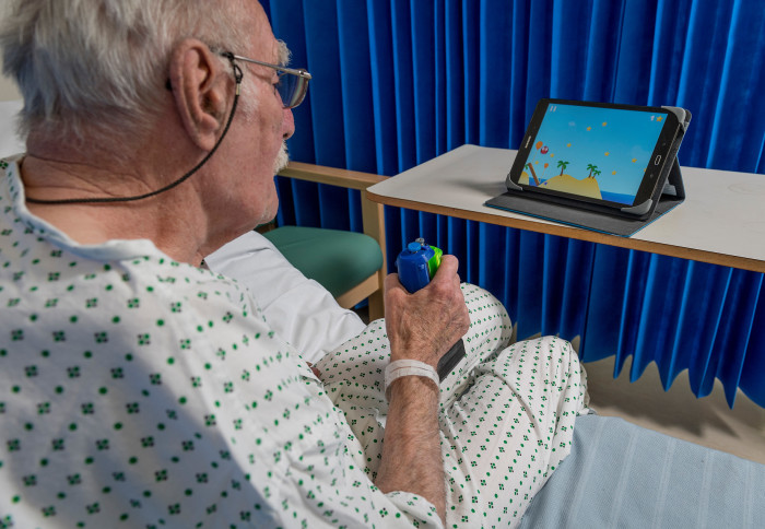 A patient and nurse at Charing Cross Hospital enjoy playing the game 'Gripable', designed by Imperial College researhcers, to help the patient overcome some of the after effects of his stroke, 13th November 2017Photography by Fergus BurnettAccreditatio