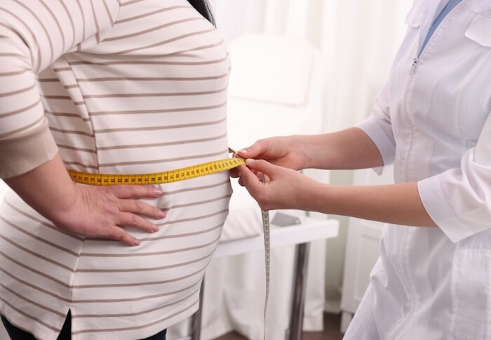 Nutritionist,Measuring,Overweight,Woman's,Waist,With,Tape,In,Clinic,,Closeup